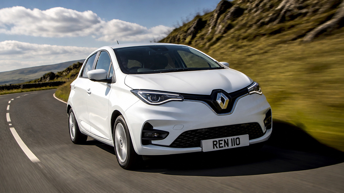 Carro branco Renault Zoe elétrico trafegando em estrada sinuosa com colinas ao fundo.